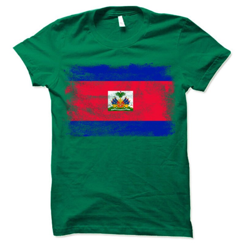 May include: A green t-shirt with a distressed, faded image of the Haitian flag. The flag is red, blue, and has a coat of arms in the center.