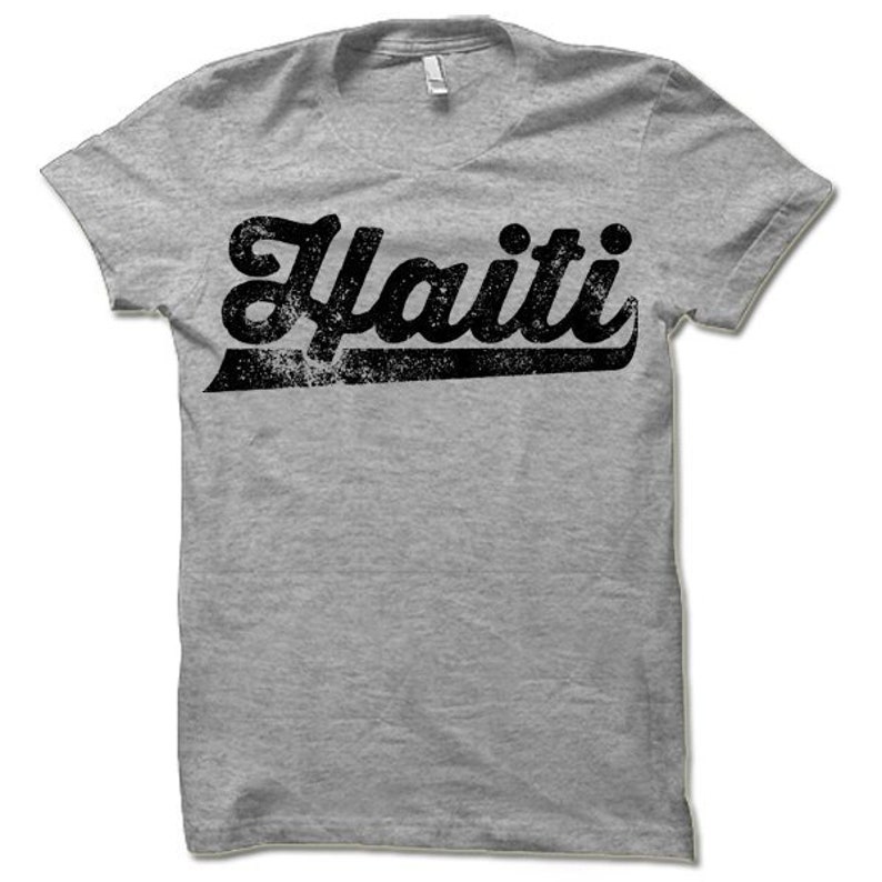 May include: A gray t-shirt with a black vintage-style graphic that says "Haiti".