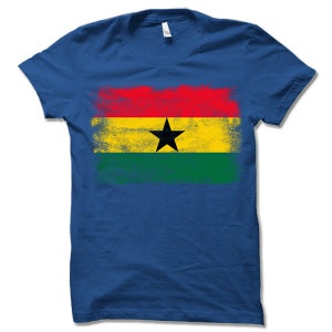 May include: A royal blue t-shirt with a distressed, faded print of the flag of Ghana. The flag features red, yellow, green, and a black star.