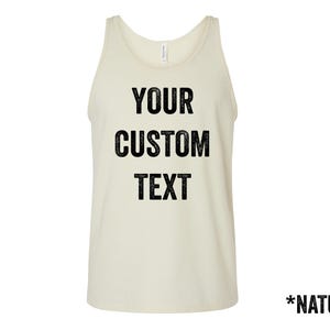 May include: A natural-colored tank top with the text "YOUR CUSTOM TEXT" printed in black. The tank top is sleeveless and has a scoop neck. The word "NATURAL" is printed at the bottom.