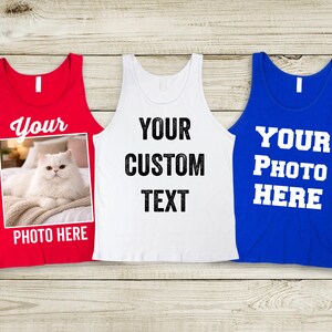 May include: Three tank tops in red, white, and blue. The red tank top has a photo of a white cat and the text "Your Photo Here". The white tank top has the text "Your Custom Text". The blue tank top has the text "Your Photo Here".