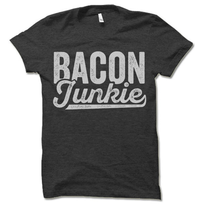 May include: A dark gray t-shirt with a white distressed graphic that says "Bacon Junkie".