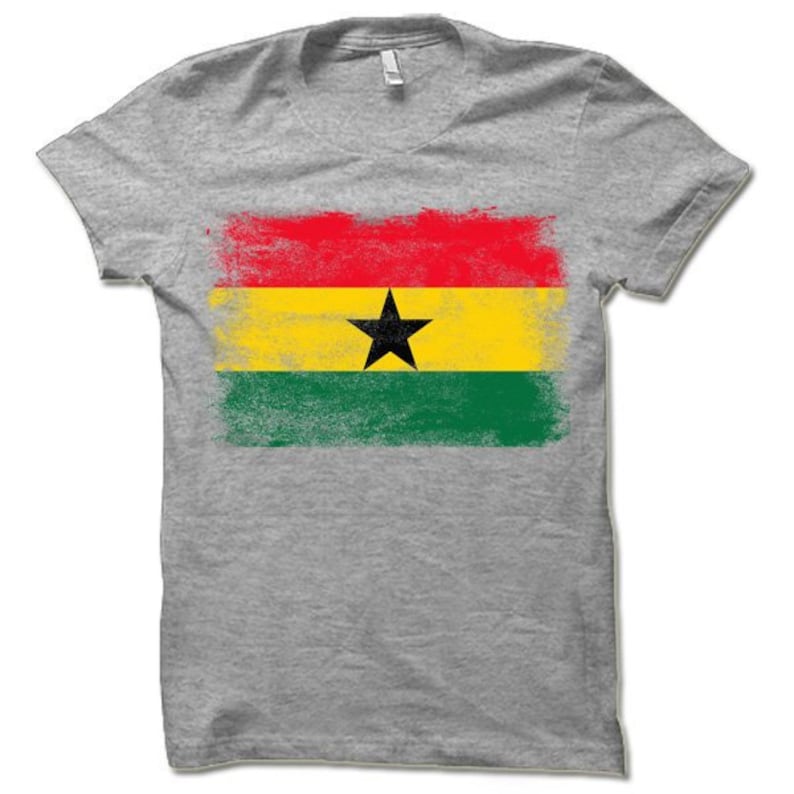 May include: A gray t-shirt with a distressed, faded print of the flag of Ghana. The flag is red, yellow, and green with a black star in the center.