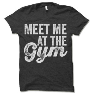 May include: Dark grey t-shirt with a white distressed graphic that says "Meet me at the gym".