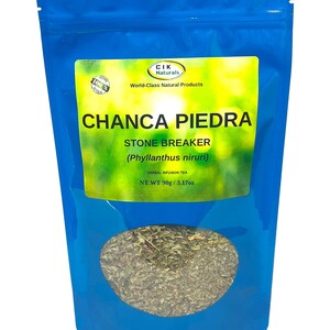 May include: A blue pouch of Chanca Piedra herbal tea. The label reads "CHANCA PIEDRA STONE BREAKER (Phyllanthus niruri)" and "HERBAL INFUSION TEA". The pouch contains dried herbs and the net weight is 3.17oz.