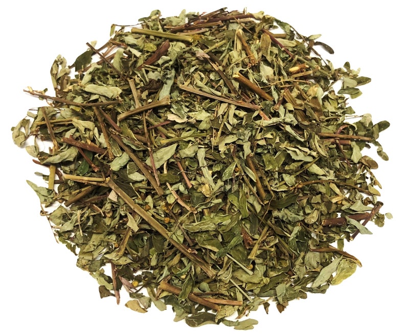 May include: A pile of dried, green herbs with brown stems and leaves. The herbs are densely packed, with a variety of shapes and sizes. The image is taken against a white background, highlighting the natural colors and textures of the herbs.