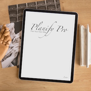 May include: A white digital tablet with a black border and a black stylus. The screen displays the text "Planify Pro Plan Your Own Way" in a black cursive font. The text "Editor" is in the bottom right corner of the screen.