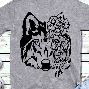 May include: A gray t-shirt with a black and white graphic of a wolf's head with floral designs on one side.