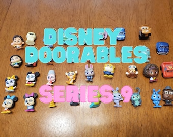 May include: A collection of 18 Disney Doorables Series 9 figures. The figures are small, colorful, and feature characters from various Disney movies. The figures include Mickey Mouse, Minnie Mouse, Buzz Lightyear, Woody, and more.