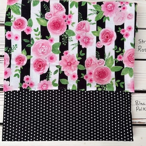 May include: Fabric featuring pink roses and green leaves on a black and white striped background. The lower section displays black fabric with white polka dots. Text reads "Striped Roses" and "Black Polka Dots."