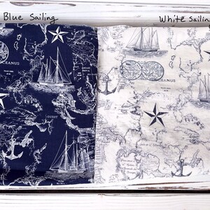 May include: Two fabrics with a nautical theme are shown, one navy blue and one white. Both have a map design with sailboats, anchors, and star accents. The text "Blue sailing" and "White sailing" are visible.