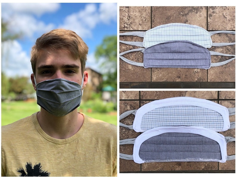 May include: A person wears a grey face mask with pleats and white trim. Other masks in blue and white check and grey fabric are displayed. The masks have fabric ties for securing around the ears.