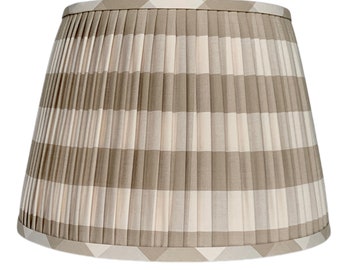 May include: A pleated lampshade with a beige and white gingham pattern.