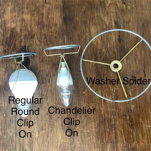 May include: Three different types of light bulb clips. The first is a regular round clip, the second is a chandelier clip, and the third is a washer spider.