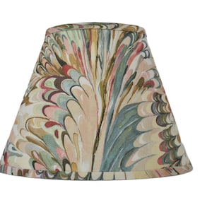 May include: A lampshade with a colorful marbled pattern in shades of pink, green, brown, and beige. The pattern resembles swirling feathers.