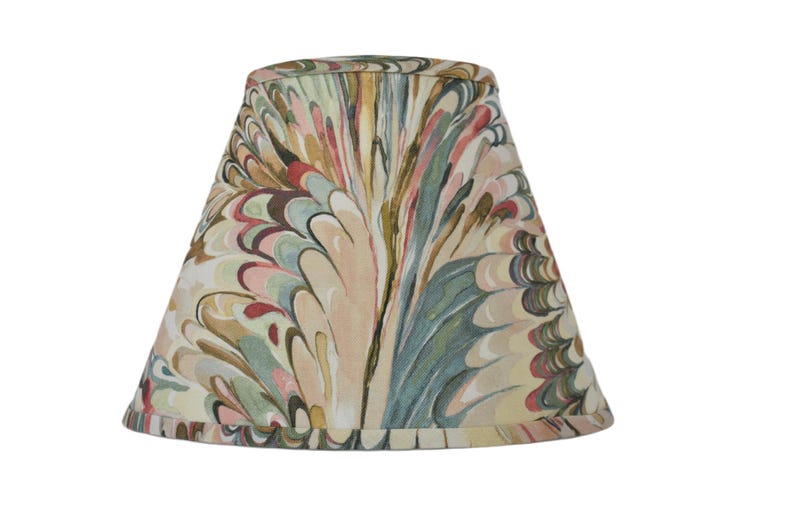 May include: A lampshade with a colorful marbled pattern in shades of pink, green, brown, and beige. The pattern resembles swirling feathers.
