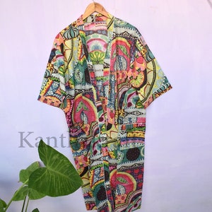 May include: A colorful patterned kimono robe with a long sleeve and a tie closure. The robe is made of a lightweight fabric and features a variety of colors and patterns, including pink, yellow, green, and blue.