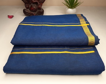May include: A folded blue cotton fabric with a yellow border. The fabric is folded in half and has a yellow stripe running along the edge.
