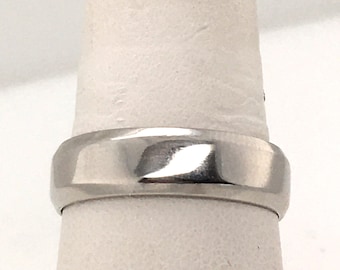 May include: A silver wedding band with a polished finish.