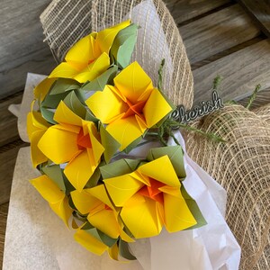 a view of the flowers made from this DIY kit, in yellow, arranged together as a bouquet, wrapped to be gifted to a loved one