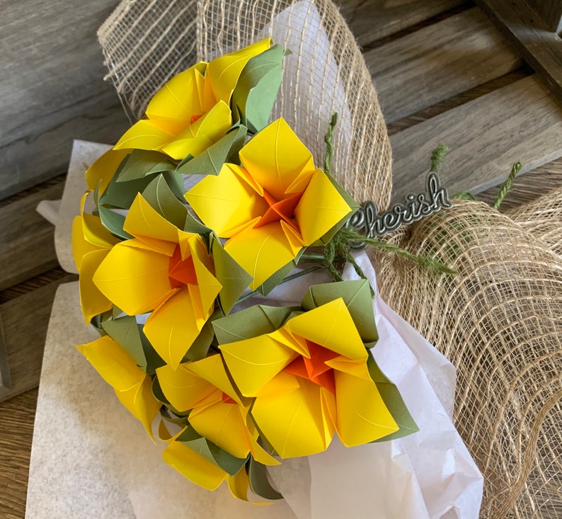 a view of the flowers made from this DIY kit, in yellow, arranged together as a bouquet, wrapped to be gifted to a loved one