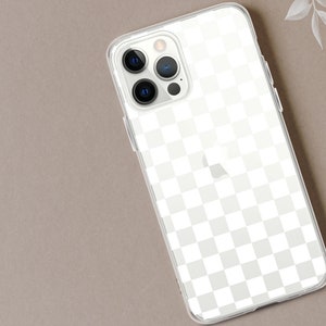 May include: Clear phone case with a white checkered pattern. The case has a transparent design, showcasing the phone's features. The phone case is on a neutral-toned surface, with a hint of floral accents in the background.