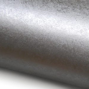 May include: Close-up of a roll of silver metallic textured paper. The paper has a subtle, irregular pattern with a slightly reflective surface. The paper is rolled up, revealing its texture and color.