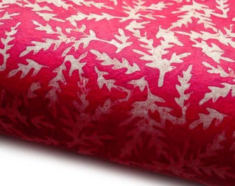 May include: Close-up of a textured, red paper with a repeating white leaf pattern. The paper has a slight sheen and a gradient of color from a deep red to a lighter shade. The leaf design is consistent throughout.