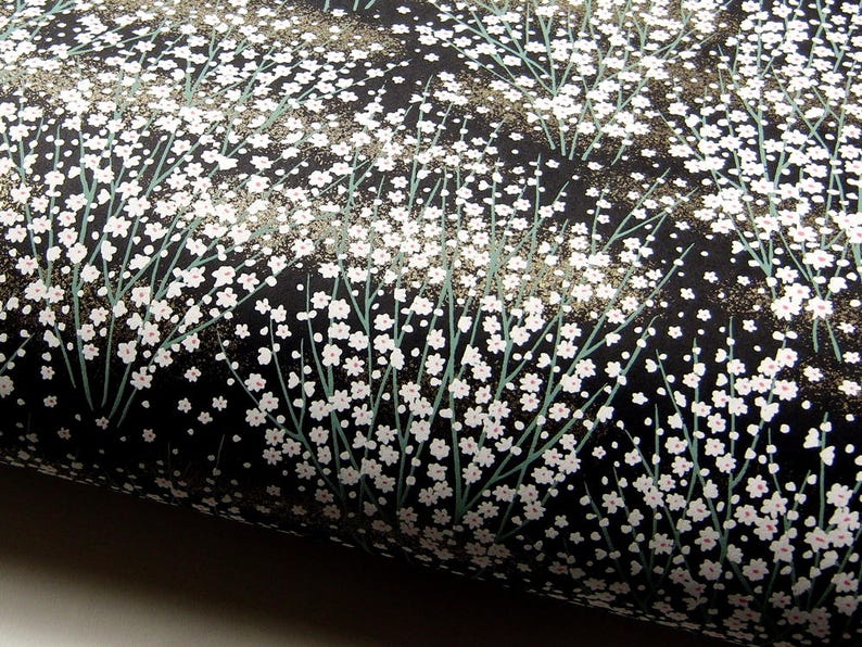 May include: Black fabric with a white floral pattern. The fabric has a subtle shimmer.
