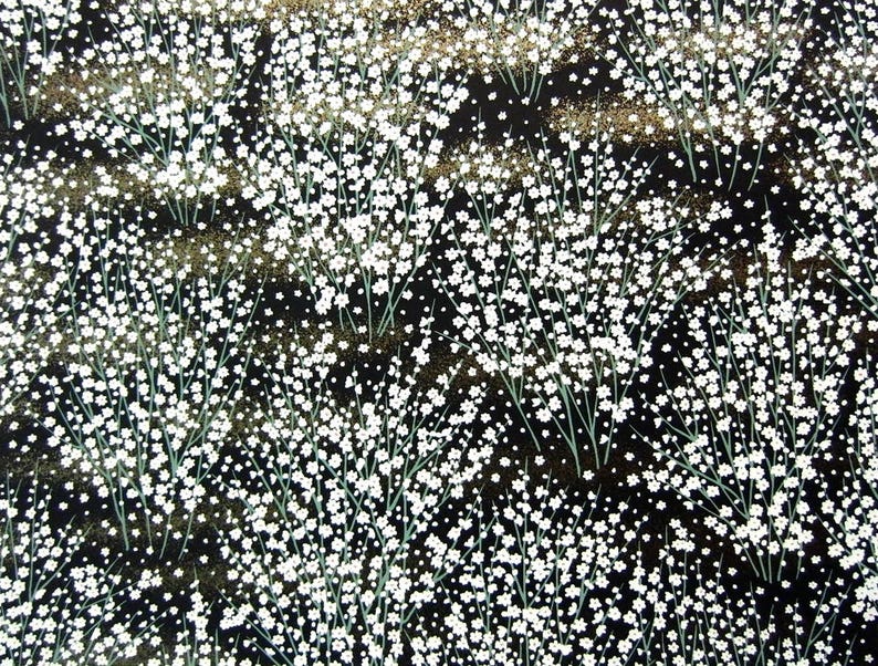 May include: Black fabric with a white floral pattern. The fabric is covered in small white flowers on thin stems. The background is black with a subtle gold shimmer.