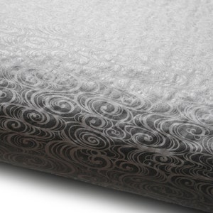 May include: A roll of black and white patterned wrapping paper with a gradient effect. The pattern is a repeating swirl design.