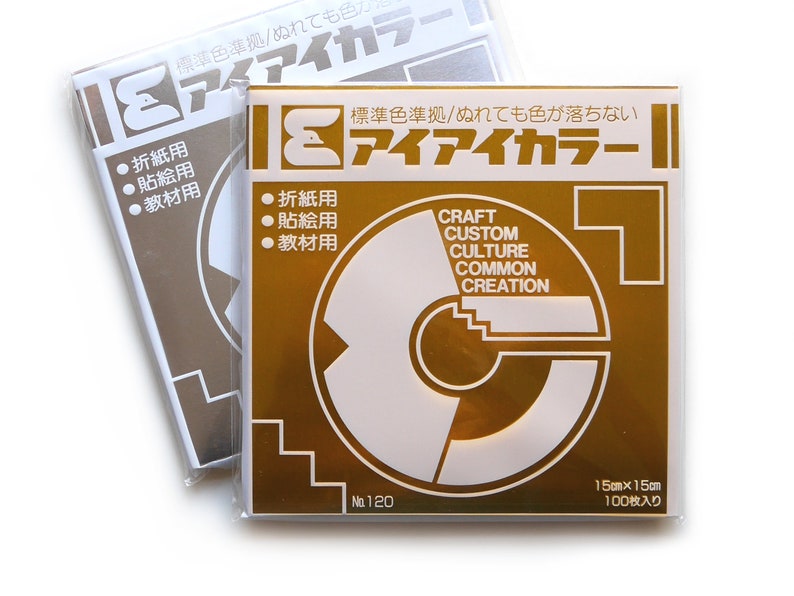 May include: A pack of 100 gold-coloured 15cm by 15cm sheets of paper. The paper is labelled "Craft Custom Culture Common Creation" and "アイアイカラー" in Japanese. The paper is for origami, crafts, and other projects.