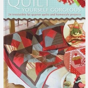 May include: A book cover with the title "Quilt Yourself Gorgeous" and the subtitle "24 irresistible fat quarter quilts and homestyle projects." The image shows a patchwork quilt in red, brown, and blue tones, with a matching pillow. Additional quilt projects are shown.