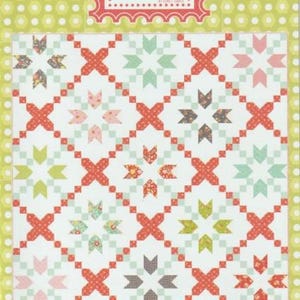 May include: A quilt pattern featuring a repeating cross stitch design in red, green, pink, and brown on a white background. The pattern is labeled "#123 Cross Stitch" with the text "make something beautiful" below. The top of the image has the text "Coriander Quilts".