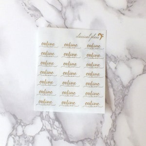 May include: A sheet of clear stickers with the word "online" written in gold cursive lettering. The stickers are arranged in a grid pattern with three rows and six columns. The text "classical plans" is written in cursive at the top of the sheet.
