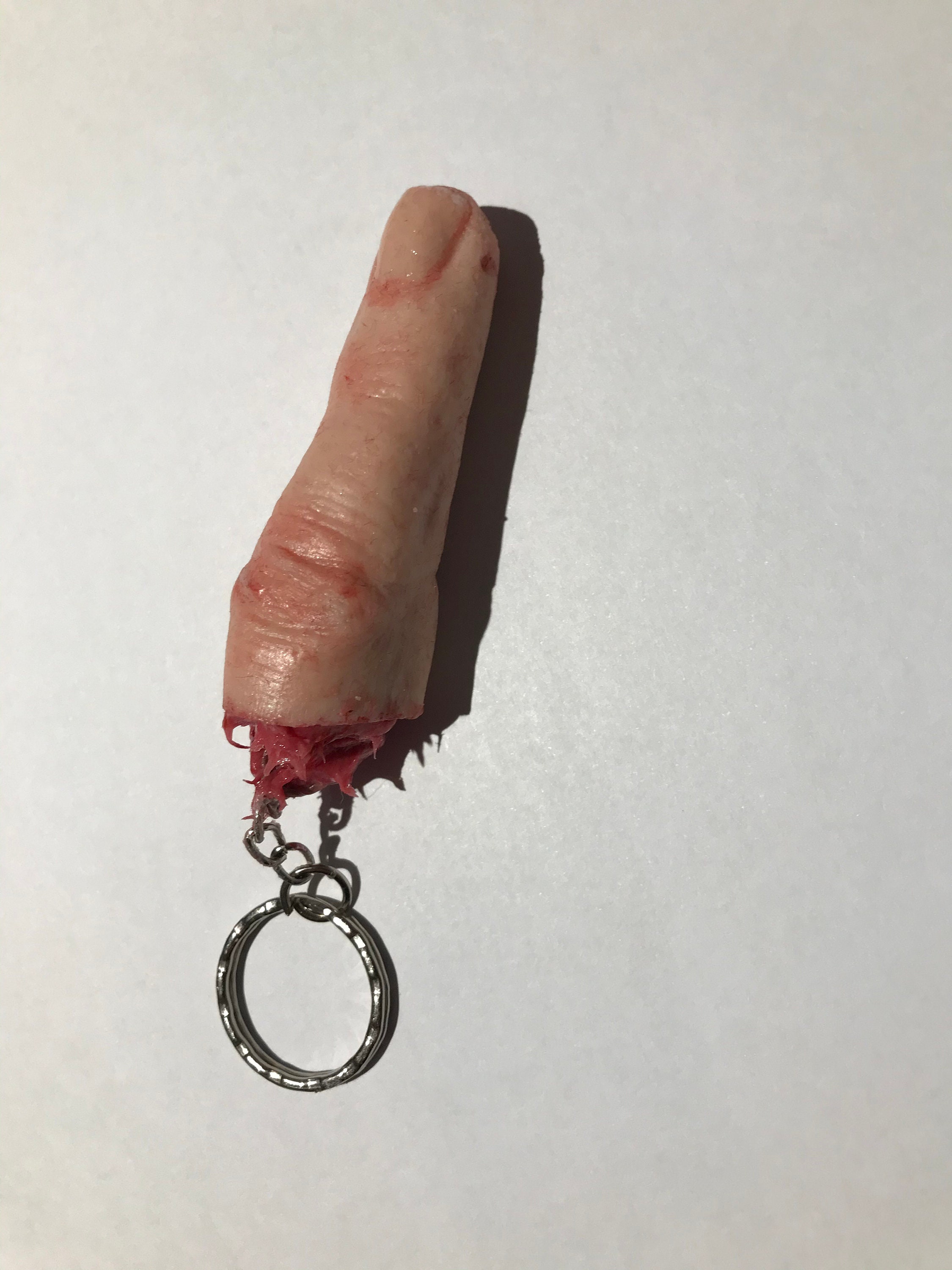 Severed silicone finger on a keyring