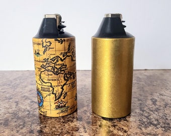 Pair Of Vintage Cricket Lighter Sleeves, "Wild Cricket" Table Lighter, Old World Map & Gold