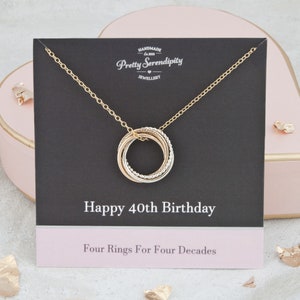 May include: Gold necklace with four interlocking rings, a gift for a 40th birthday. The card reads "Happy 40th Birthday" and "Four Rings For Four Decades".