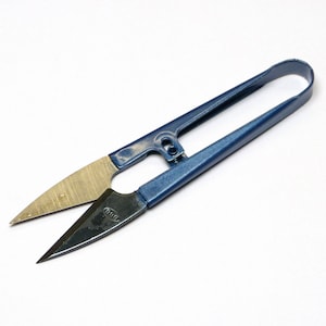May include: Blue metal fabric shears with a gold-coloured blade. The shears have a small oval-shaped logo on the handle that says "GMB".