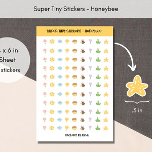 May include: A sheet of 99 tiny stickers featuring a variety of cute designs, including honeybees, flowers, clouds, and honeycomb. The sheet measures 4 inches by 6 inches and each sticker is approximately 0.3 inches in diameter. The stickers are printed on white paper with a light pink, yellow, and green color scheme.