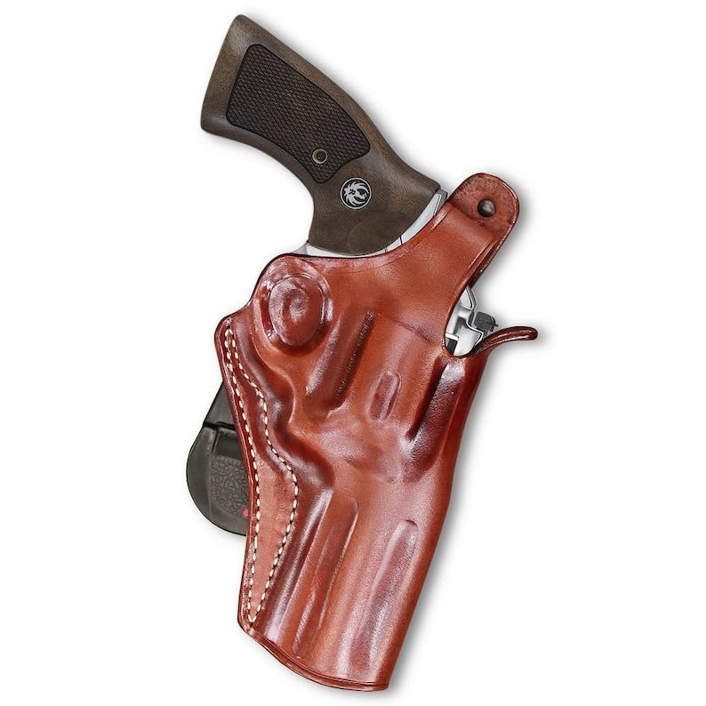 May include: A brown leather holster for a handgun. The holster has a stitched design and a belt loop.