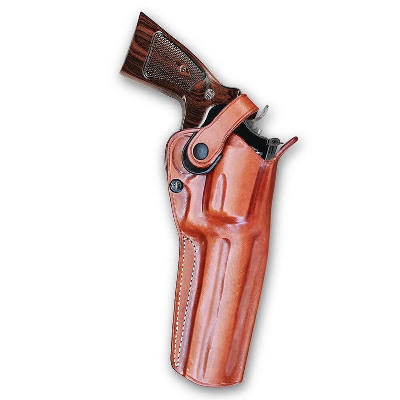 May include: A brown leather holster with a stitched design and a black metal clip. A revolver is partially visible inside the holster.