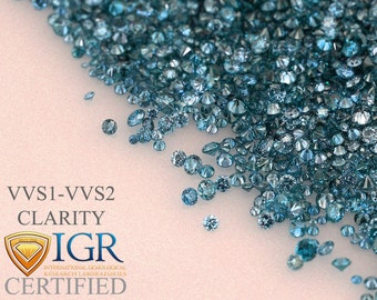 May include: A collection of small, round, teal-colored diamonds scattered on a light background. The image includes text that reads "VVS1-VVS2 CLARITY IGR CERTIFIED" with a logo.