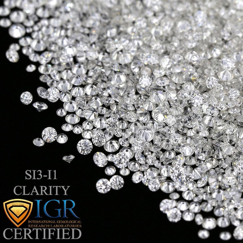 May include: A collection of sparkling, clear diamonds against a black background. The diamonds vary in size and are densely packed, reflecting light. The image includes text indicating SI3-I1 clarity and IGR certification.