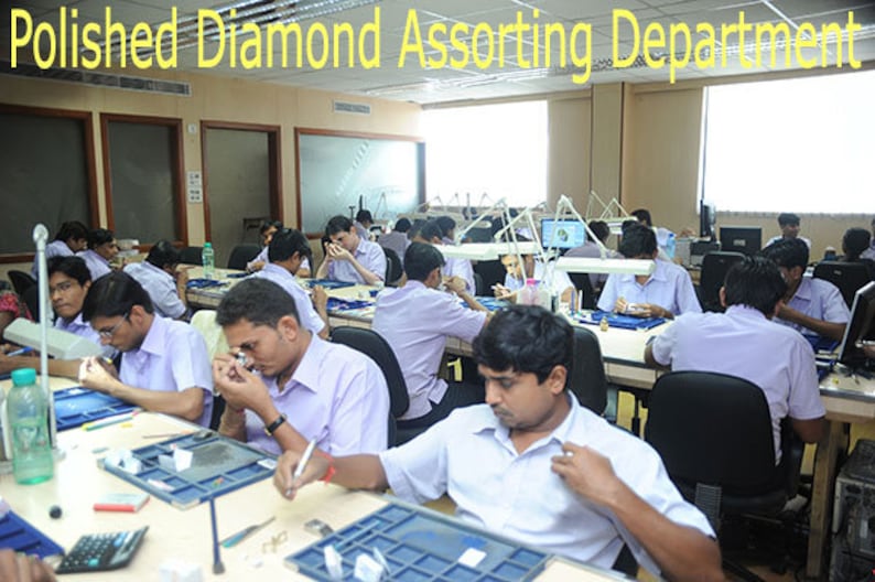 May include: An interior shot of a diamond sorting department. Several people are seated at tables, examining diamonds with magnifying glasses and small tools. The text "Polished Diamond Assorting Department" is at the top of the image.