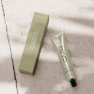 May include: A green tube of Oasis Daily Sunscreen with a white label and black text. The tube is labeled "For All Skin Types" and "Daily Sunscreen Mineral Body Sunscreen Broad Spectrum SPF 30 1.7 fl oz (50 ml)".