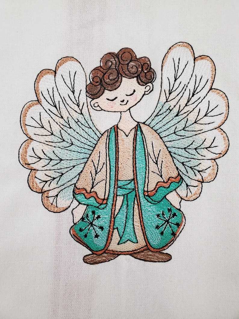 May include: Embroidered image of a serene angel with brown curly hair, closed eyes, and large detailed wings. The angel wears a tan robe with teal accents and a teal sash. The wings have a tan and teal color scheme.