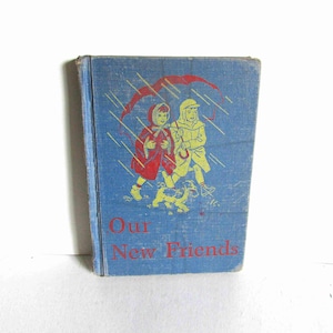 May include: A vintage children's book titled "Our New Friends" with a blue cover. The cover features an illustration of two children walking with a dog in the rain under an umbrella.