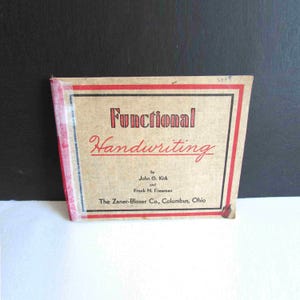 May include: A vintage book titled "Functional Handwriting" with a tan cover and red and black accents. The book's title is in a decorative font, and the authors' names and publisher are also visible.