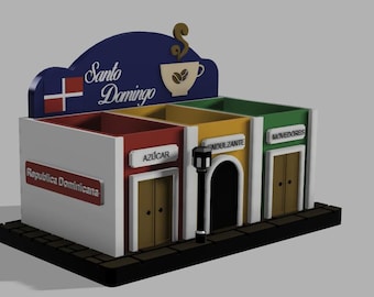 Puede incluir: Un organizador de condimentos para café con varios compartimentos en forma de fachada con un letrero azul que dice Santo Domingo, etiquetas para Azúcar, Endulzante y Movedores, y la bandera de la República Dominicana.